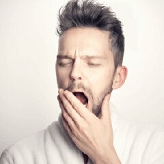 A tired person beginning a bedtime routine