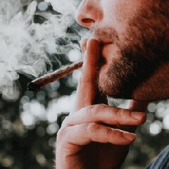 A person smoking, representing a tobacco-free wellness goal